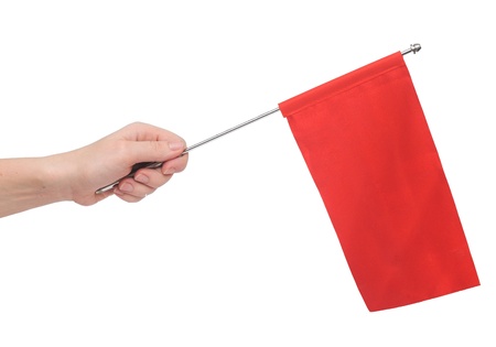 Hand holding a red flag isolated on white background. Put your own textの写真素材