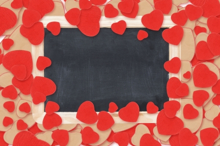 blank chalkboard over Valentine hearts backgroundの写真素材