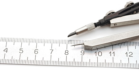closeup  compasses and rulers on a white paper.の写真素材