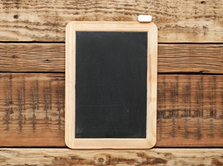 Blackboard on the wood wall.の写真素材