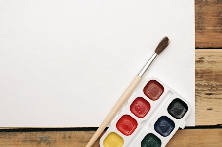 paint buckets and brush on wooden backgroundの写真素材