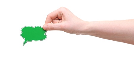 Hand holding a small speech bubble symbolの写真素材