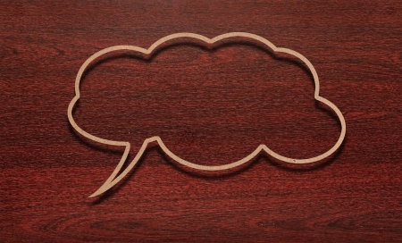 blank recycled paper speech bubble on wood backgroundの写真素材