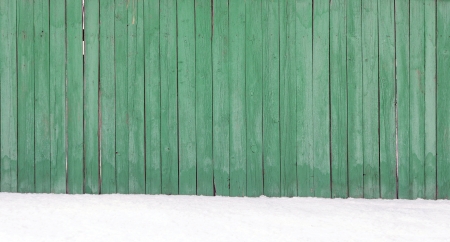 Old wooden fence in a snow drift の写真素材