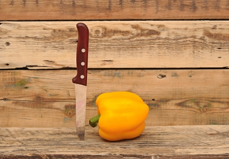 paprika and knife on wooden backgroundの写真素材