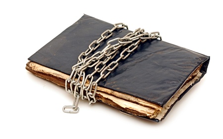 old book with chain isolated on white background の写真素材