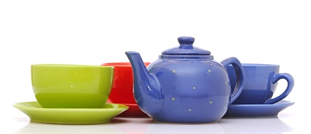 colorful tea cups with teapot isolated on whiteの写真素材