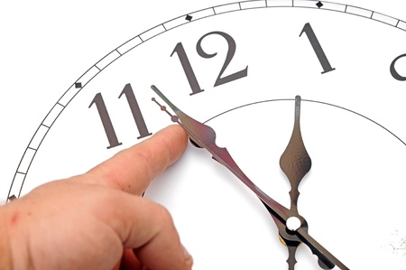 man hands manipulating hands of clock 