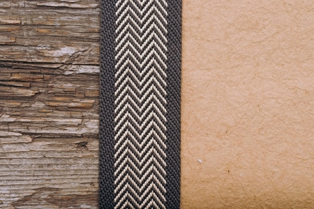 Wooden background with brown ribbon on brown crumpled paper の写真素材