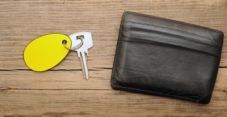 wallet and key with blank label on wood backgroundの写真素材