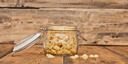 Pasta in the form of shells in a glass jar の写真素材