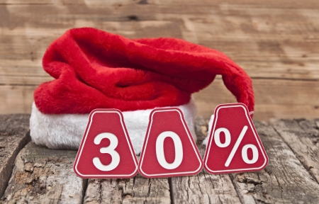 30 percent with santa hat on old wooden background