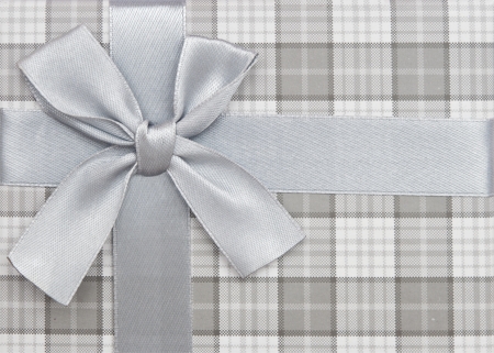 gift box with silver ribbon and bow isolated on white background, top view の写真素材