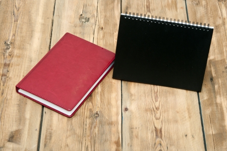 desk calendar with red leather note book on wood table の写真素材