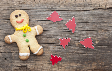 homemade christmas painted gingerbreads (gingerbread man) on the wooden background