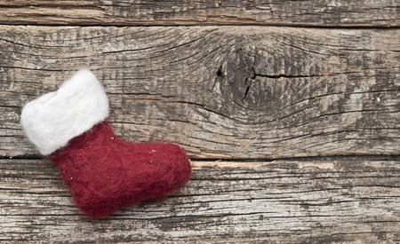 Santa or christmas boot on a wooden background for a greeting cardの写真素材