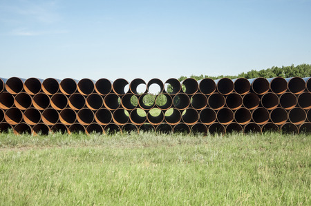 closeup of a pile of large and rusting steel pipes