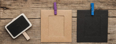 blank small black chalkboard with photo frame on wood backgroundの写真素材