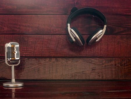 Microphone and headphones on wooden backgroundの写真素材