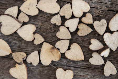 wooden hearts placed nicely on vintage wood backgroundの写真素材