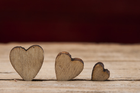 wooden hearts placed nicely on vintage wood backgroundの写真素材