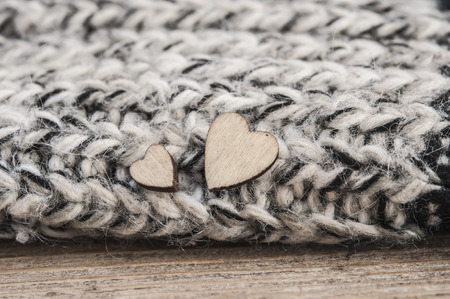 wooden hearts symbol of love, in knitted woolen scarfの写真素材