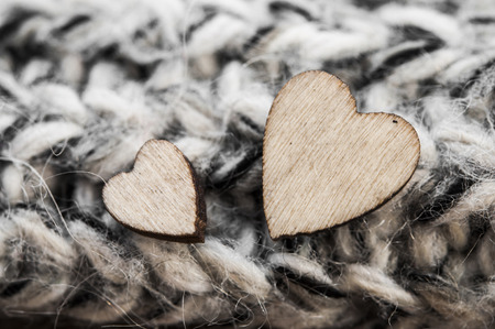 wooden hearts symbol of love, in knitted woolen scarfの写真素材