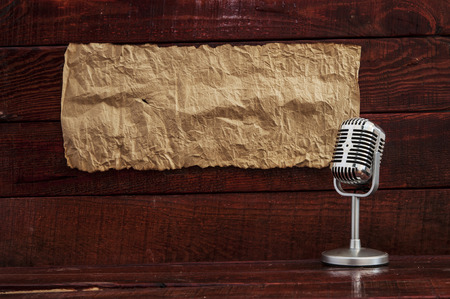 Retro microphone on table with blank paper. Space for text.の写真素材