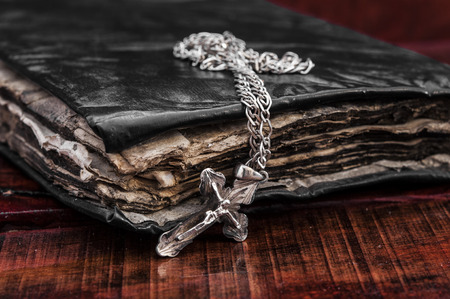 Closeup of silver Christian cross on bibleの写真素材