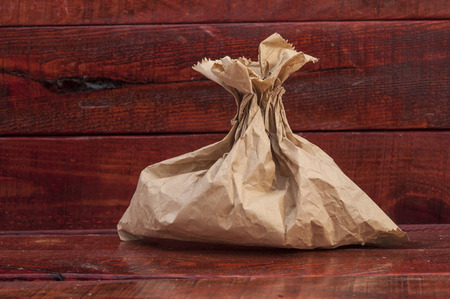 simple brown paper bag for lunch or food on wooden tableの写真素材
