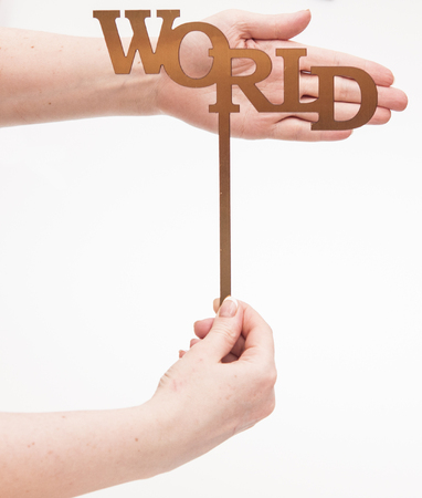 Hand holding a paper card with Earth day word on white backgroundの写真素材