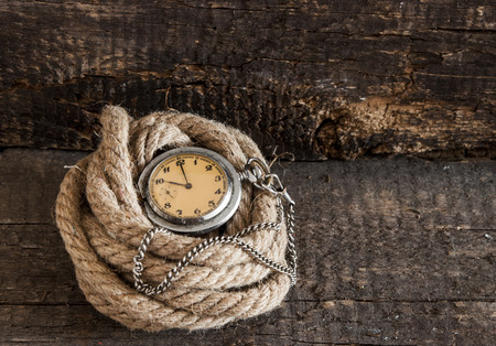 Old pocket watch on a textured vintage backgroundの写真素材