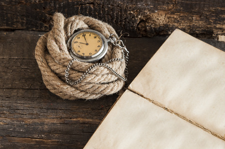 Old pocket watch on a textured vintage backgroundの写真素材