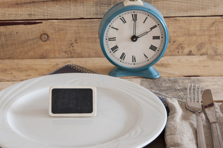 Meal time table place setting with alarm clock