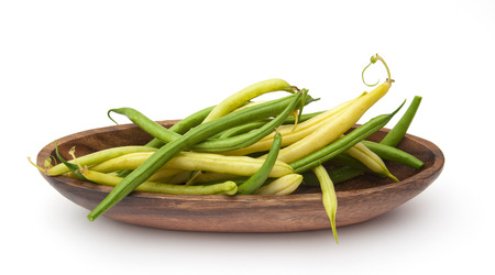 Harvest of asparagus siliculose yellow and green beans. Isolated on white