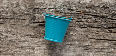 colorful bucket on wood tableの写真素材