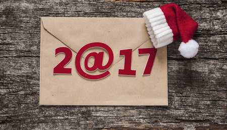 Happy new year 2017 - paper envelope on wooden table 