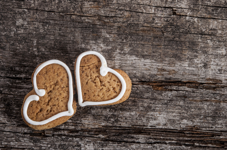 close-up of gingerbread in the shape of hearts on old wood backgroundの写真素材