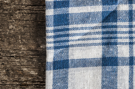Blue checkered tablecloth on wooden table