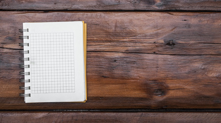 blank notebook page is on top of wood office desk tableの写真素材