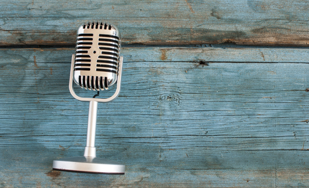 Retro microphone on wooden tableの写真素材