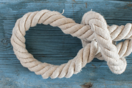 White rope on blank antique blue rustic wooden background