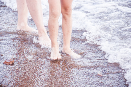 Feet of child in the sea wavesの写真素材