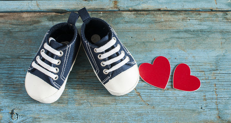 Cute little baby shoes on wood background , top viewの写真素材