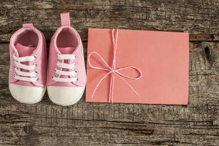 Cute little baby shoes on wood background , top viewの写真素材