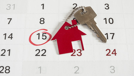A house key on a calendar background, paying your mortgage on timeの写真素材