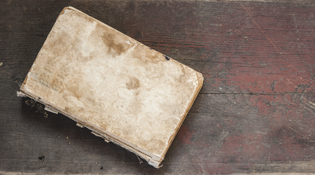 old books lies on a wooden backgroundの写真素材