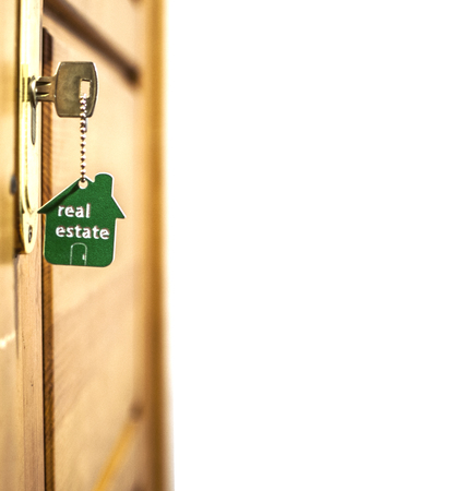 Symbol of the house and stick the key in the keyholeの写真素材