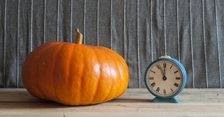 background with big yellow pumpkin on wooden boardの写真素材