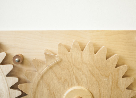 colorful gears on the brown wooden backgroundの写真素材